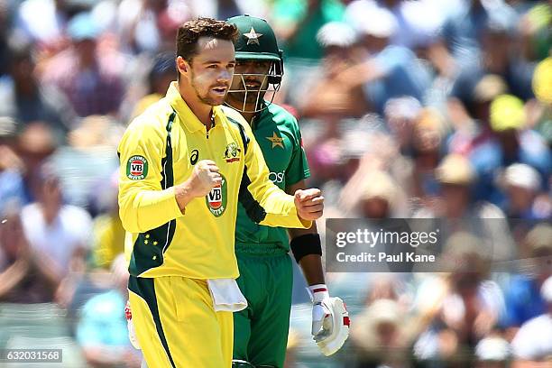 Travis Head of Australia celebrates the wicket of Asad Shafiq of Pakistan during game three of the One Day International series between Australia and...