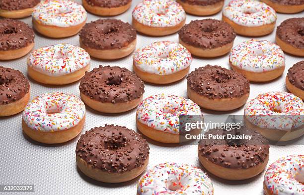 doughnuts white and chocolate on production line - how many calories are in a chocolate donut stock pictures, royalty-free photos & images