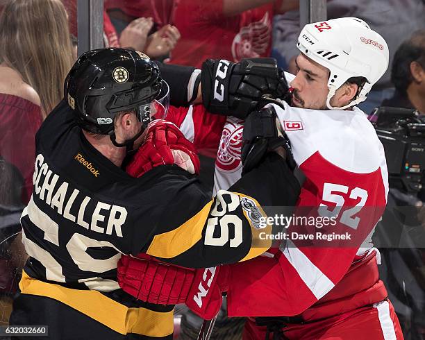 Tim Schaller of the Boston Bruins gets into a scrum with Jonathan Ericsson of the Detroit Red Wings during an NHL game at Joe Louis Arena on January...