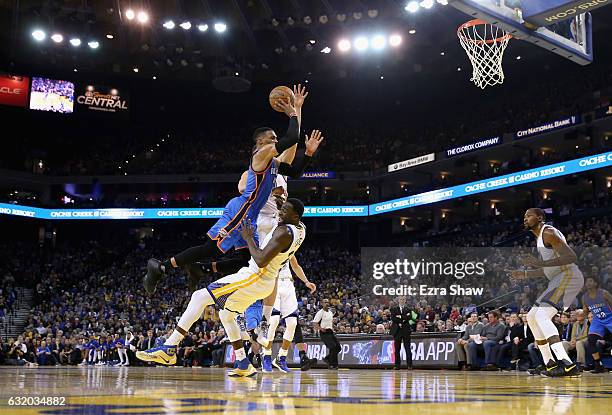 Draymond Green of the Golden State Warriors draws an offensive foul on Russell Westbrook of the Oklahoma City Thunder at ORACLE Arena on January 18,...