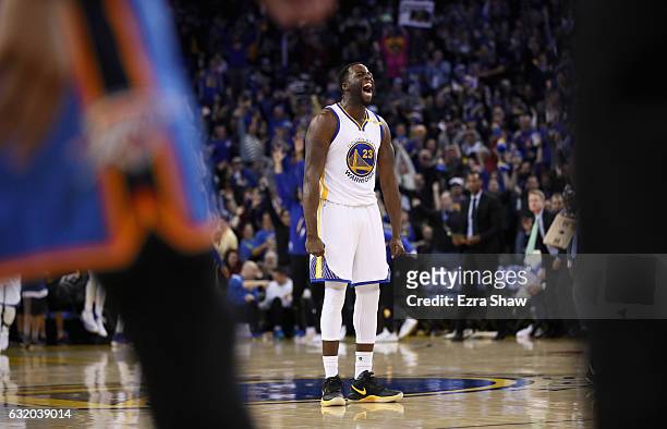 Draymond Green of the Golden State Warriors reacts after Klay Thompson made a three-point basket against the Oklahoma City Thunder at ORACLE Arena on...