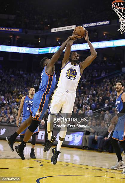 Kevin Durant of the Golden State Warriors is fouled by Jerami Grant of the Oklahoma City Thunder at ORACLE Arena on January 18, 2017 in Oakland,...