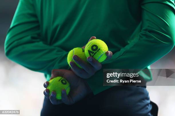 Tennis balls are held by a ball kid during the second round match between Denis Istomin of Uzbekistan and Novak Djokovic of Serbia on day four of the...