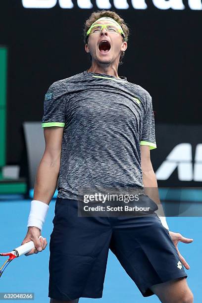 Denis Istomin of Uzbekistan celebrates winning his second round match against Novak Djokovic of Serbia on day four of the 2017 Australian Open at...