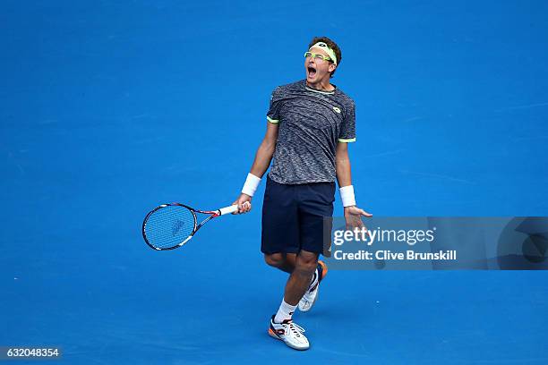 Denis Istomin of Uzbekistan celebrates winning his second round match against Novak Djokovic of Serbia on day four of the 2017 Australian Open at...