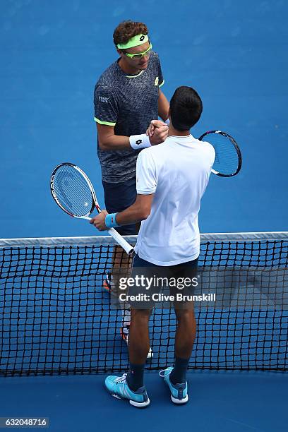 Novak Djokovic of Serbia congratulates Denis Istomin of Uzbekistan after winning their second round match on day four of the 2017 Australian Open at...