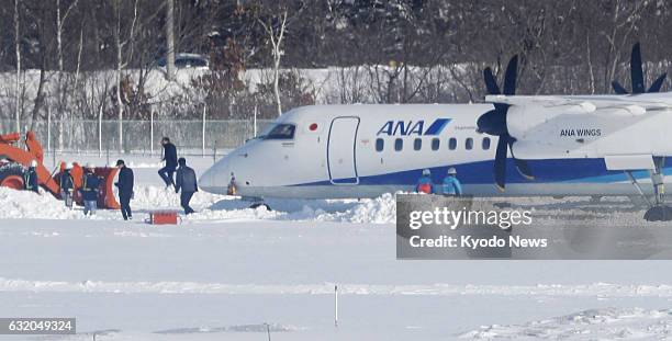 An All Nippon Airways plane overruns and stops outside a runway at New Chitose Airport near Sapporo on Japan's northernmost main island of Hokkaido...