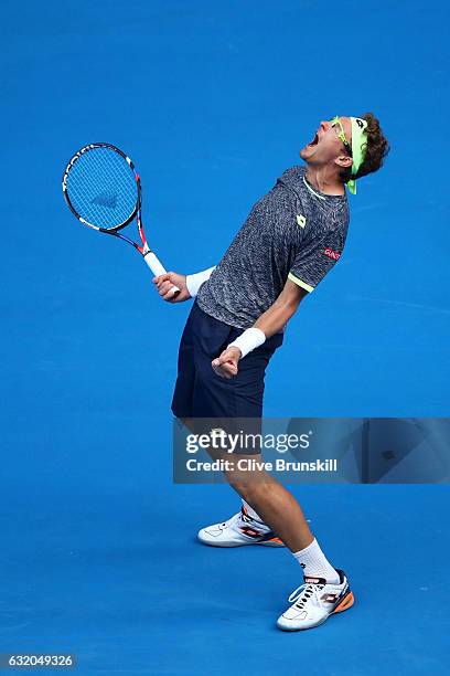 Denis Istomin of Uzbekistan celebrates winning his second round match against Novak Djokovic of Serbia on day four of the 2017 Australian Open at...