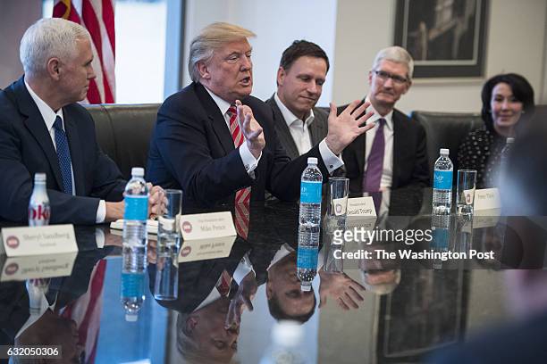 From left Vice President-elect Mike Pence, PayPal founder Peter Thiel, Apple CEO Tim Cook, and Oracle CEO Safra Catz listen to Republican...