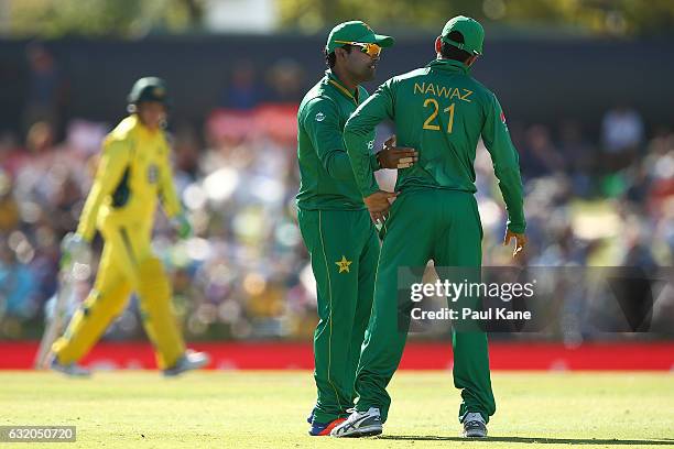 Umar Akmal of Pakistan consoles Mohammad Nawaz of Pakistan after dropping Peter Handscomb of Australia during game three of the One Day International...