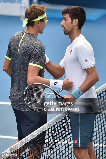 Serbia's Novak Djokovic shakes hands with Uzbekistan's Denis Istomin after defeat during their men's singles second round match on day four of the...