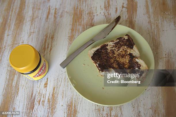 Slice of toast with Vegemite spread on its surface sits on a plate in an arranged photograph in Melbourne, Australia, on Thursday Jan. 19, 2017. Bega...