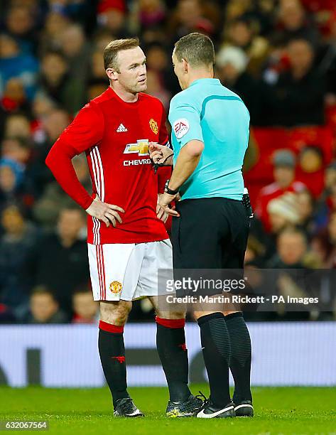 Referee Kevin Friend speaks with Manchester United's Wayne Rooney