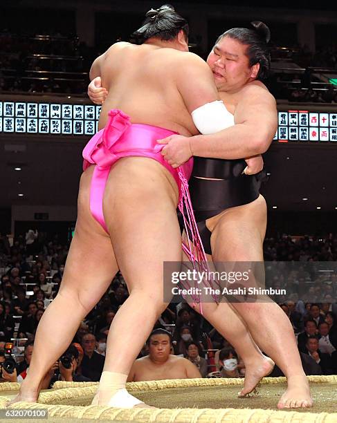 Chiyoo pushes Hidenoumi out of the ring to win during day twelve of the Grand Sumo New Year Tournament at Ryogoku Kokugikan on January 19, 2017 in...