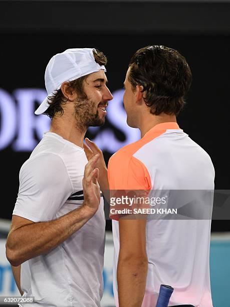 Australia's Jordan Thompson congratulates Austria's Dominic Thiem for his victory in their men's singles second round match on day four of the...