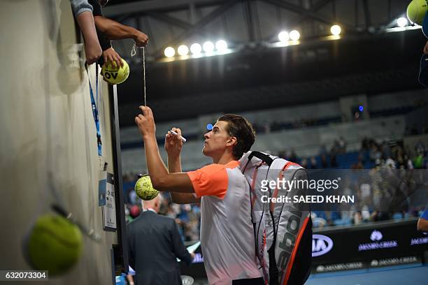 Austria's Dominic Thiem signs autographs after his victory against Australia's Jordan Thompson during their men's singles second round match on day...