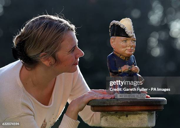 Auctioneer Catherine Southon checks a Clarice Cliff Churchill Toby jug, 1 of 350 ever produced dating from around 1940, which is estimated to sell...