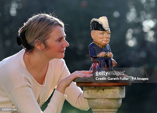 Auctioneer Catherine Southon checks a Clarice Cliff Churchill Toby jug, 1 of 350 ever produced dating from around 1940, which is estimated to sell...