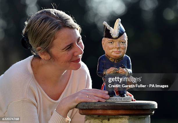 Auctioneer Catherine Southon checks a Clarice Cliff Churchill Toby jug, 1 of 350 ever produced dating from around 1940, which is estimated to sell...