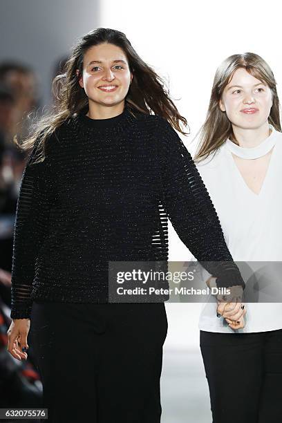 Designers Caroline Rohner and Inna Stein acknowledge the applause of the audience at the Steinrohner show during the Mercedes-Benz Fashion Week...