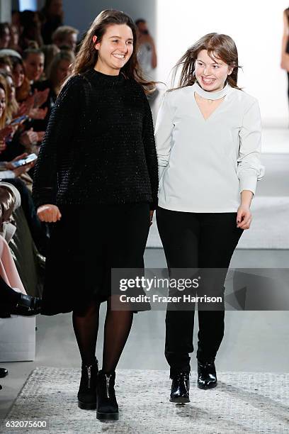 Designers Caroline Rohner and Inna Stein acknowledge the applause of the audience at the Steinrohner show during the Mercedes-Benz Fashion Week...