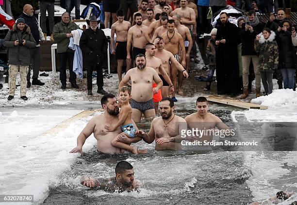 Believers swim trough the ice cold water of Ada Ciganlija lake during Epiphany celebrations on January 19, 2017 in Belgrade, Serbia. Orthodox Serbs...