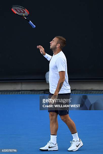 Britain's Daniel Evans catches his racquet after a point Croatia's Marin Cilic during their men's singles match on day three of the Australian Open...