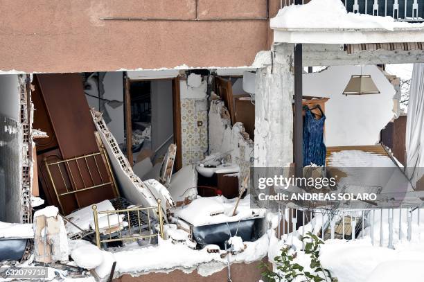 Rubble and debris of a building, destroyed in an August 2016 quake, are covered with snow in the damaged central Italian village of Amatrice, after a...