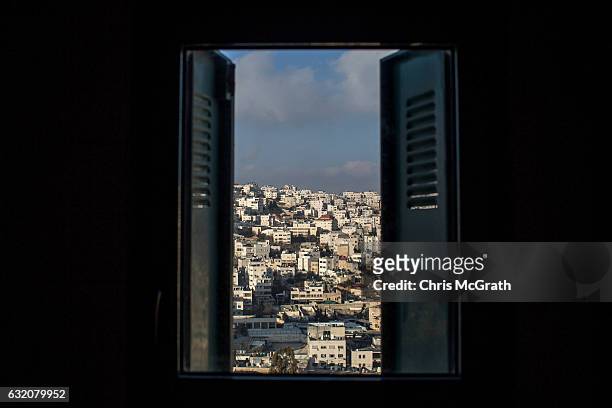Palestinian neighbourhood is seen from the window of a building inside an Israeli settlement in the city of Hebron on January 18, 2017 in Hebron,...