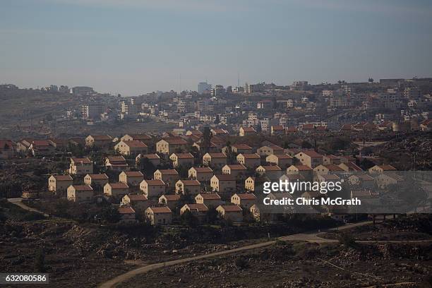 Houses part of an Israeli settlement are seen in front of an Arab town on January 16, 2017 in Amona, West Bank. 70 countries attended the recent...