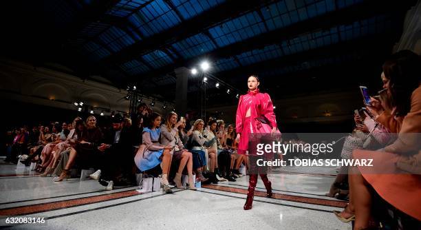 Model wears a creation by Marina Hoermanseder during the Berlin Fashion Week in Berlin on January 19, 2017. / AFP PHOTO / Tobias SCHWARZ