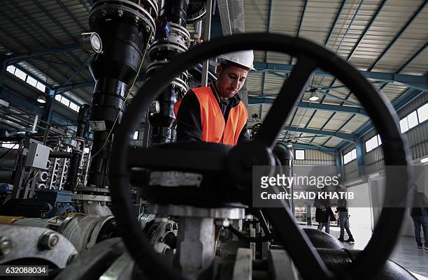 Palestinian employee works at a desalination plant during the inauguration of the first phase of the project on January 19 in Deir el-Balah in...