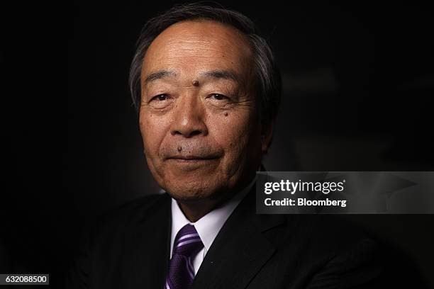 Takeshi Uchiyamada, chairman of Toyota Motor Corp., poses for a photograph following a Bloomberg Television interview at the World Economic Forum in...