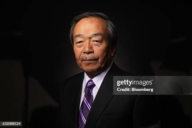 Takeshi Uchiyamada, chairman of Toyota Motor Corp., poses for a photograph following a Bloomberg Television interview at the World Economic Forum in...