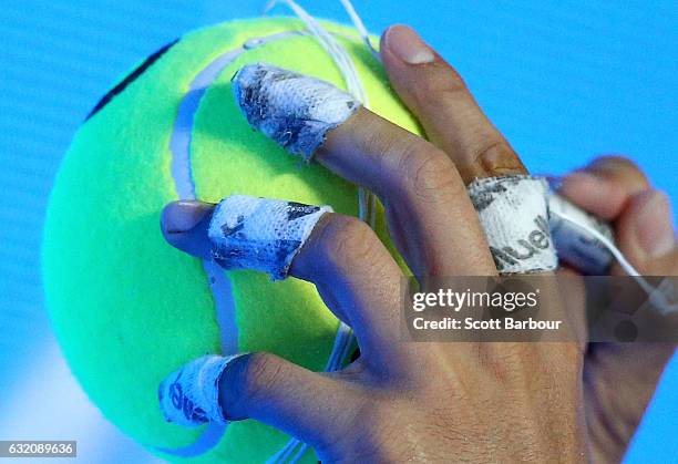 Detail of the taped up fingers of Rafael Nadal of Spain as he signs autographs after winning his second round match against Marcos Baghdatis of...