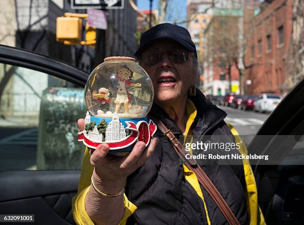 An unidentified woman holds up a snow globe she purchased at a stoop sale with a miniature character of Betty Boop inside in Brooklyn, NY, NY April...