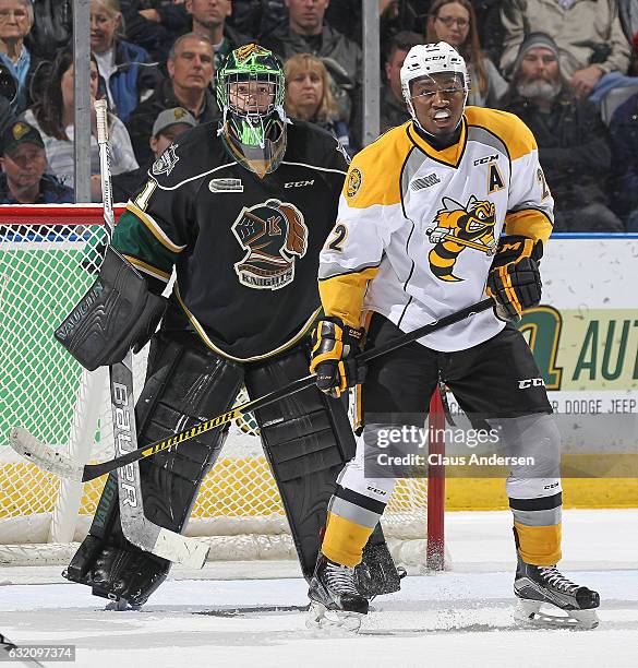 Jaden Lindo of the Sarnia Sting looks to tip a shot in front of Tyler Parsons of the London Knights during an OHL game at Budweiser Gardens on...