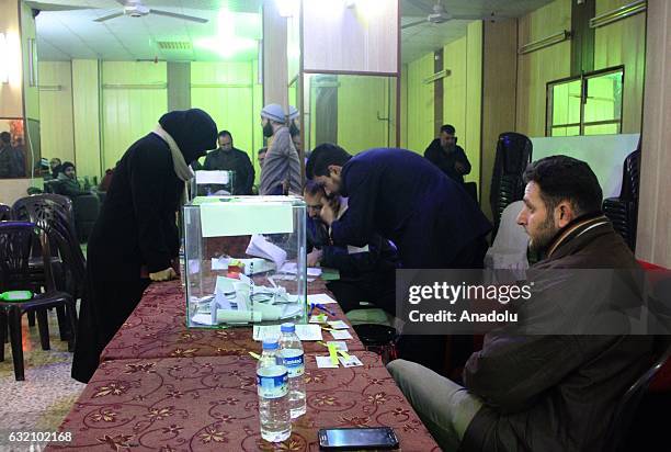 People cast their votes at a polling station after anti-regimist opposition forces group named Jaish al-Fatah handed over the management of city to...