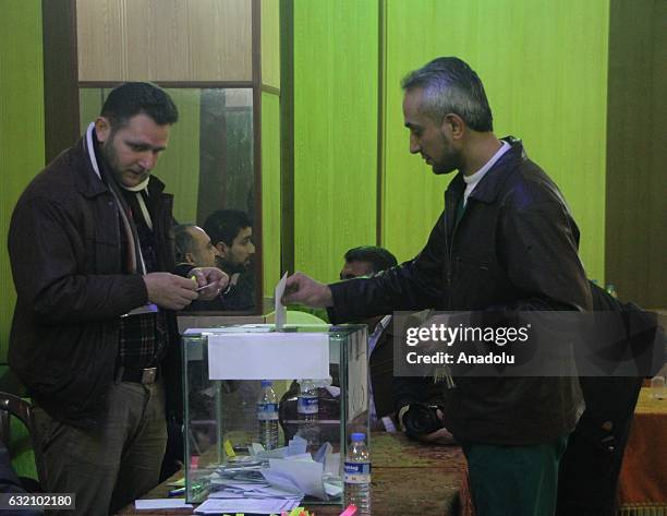 People cast their votes at a polling station after anti-regimist opposition forces group named Jaish al-Fatah handed over the management of city to...