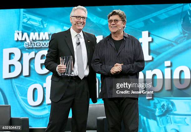 Musician Robbie Robertson receives the Music for Life Award from NAMM President and CEO Joe Lamond during the 2017 NAMM Show Opening Day at Anaheim...