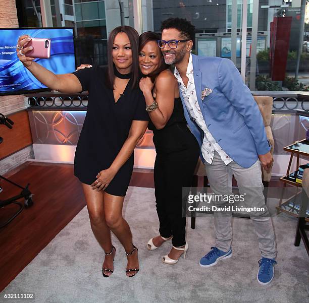 Actress/host Garcelle Beauvais, actress Robin Givens and singer Eric Benet pose at Hollywood Today Live on January 19, 2017 in Hollywood, California.