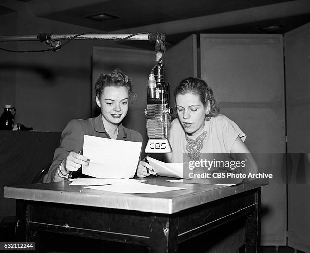 Actress June Lockhart and CBS Radio personality Radie Harris are photographed in front of a Radio Microphone. Radie Harris is the on air columnist...