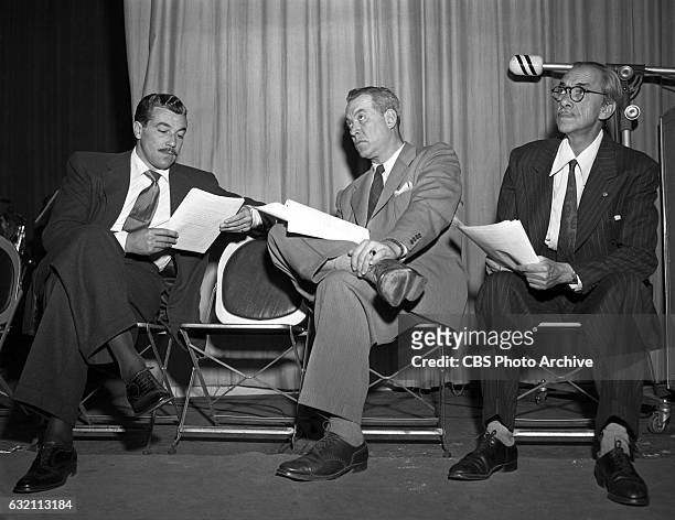 Radio's "Screen Guild Players" adaptation of the theatrical film "The Fugitive." : Cesar Romero, Ward Bond and Pedro de Cordoba await their turns for...