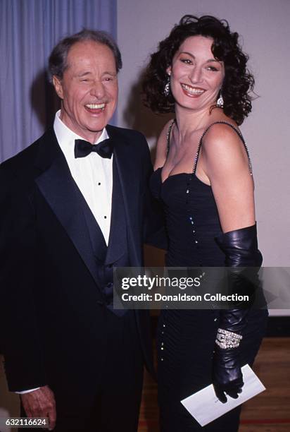 Actors Don Ameche and Anjelica Huston attends the Academy Awards in March 1987 in Los Angeles, California.