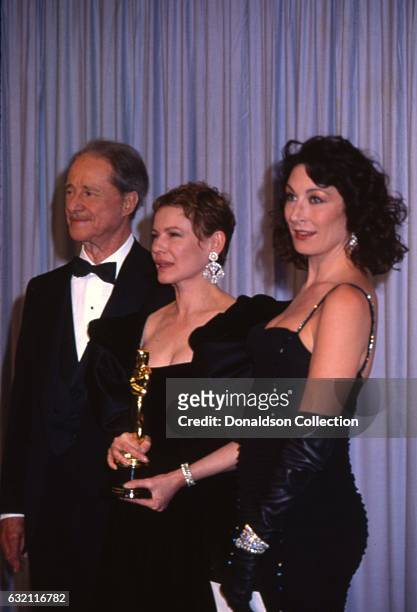 Actors Don Ameche, Dianne Wiest and Anjelica Huston attends the Academy Awards in March 1987 in Los Angeles, California.