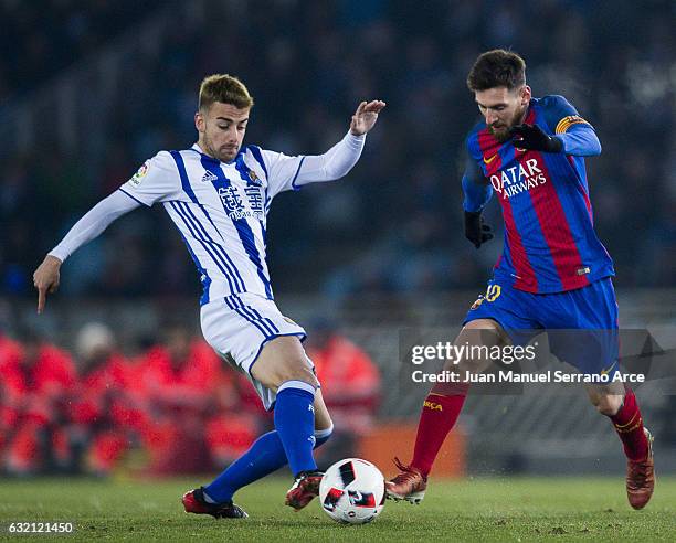 Lionel Messi of FC Barcelona duels for the ball with David Concha of Real Sociedad during the Copa del Rey Quarter Final, First Leg match between...
