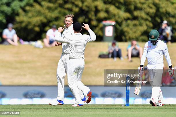 Tim Southee of New Zealand is congratulated by team mates after dismissing Tamim Iqbal of Bangladesh during day one of the Second Test match between...