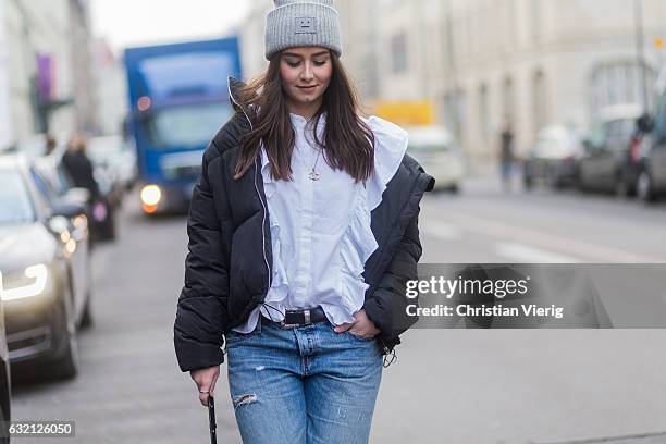 Veronique Sophie Schroeter wearing Acne beanie, down feahter jacket, ripped denim jeans, fishnet tights at Marina Hoermanseder during the...