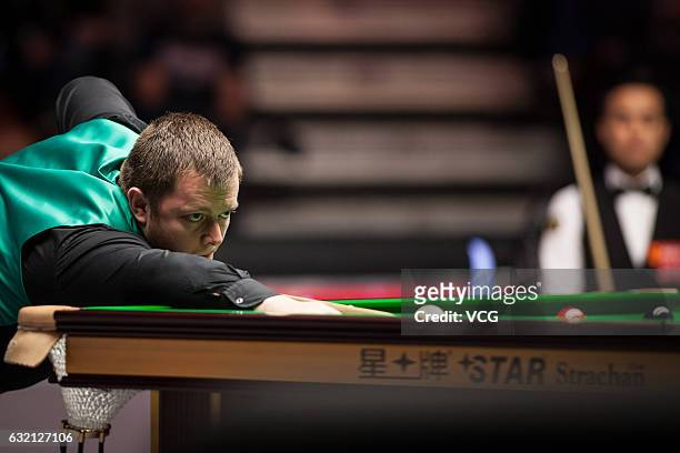 Mark Allen of Northern Ireland plays a shot during the quarterfinal match against Marco Fu of Chinese Hong Kong on day five of the Dafabet Masters at...