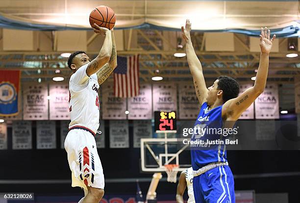 Lorenzen Wright Jr. #42 of the Robert Morris Colonials puts up a shot over Tyson Batiste of the Central Connecticut State Blue Devils in the first...
